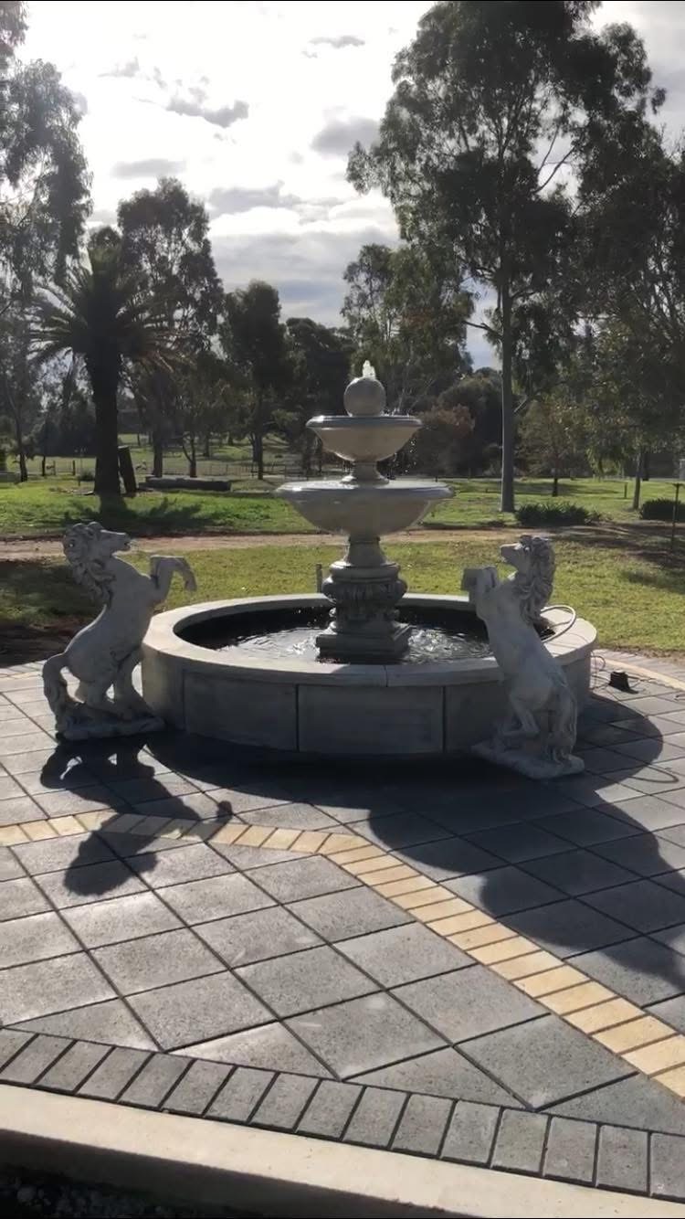 Paved courtyard laid around a stone water fountain